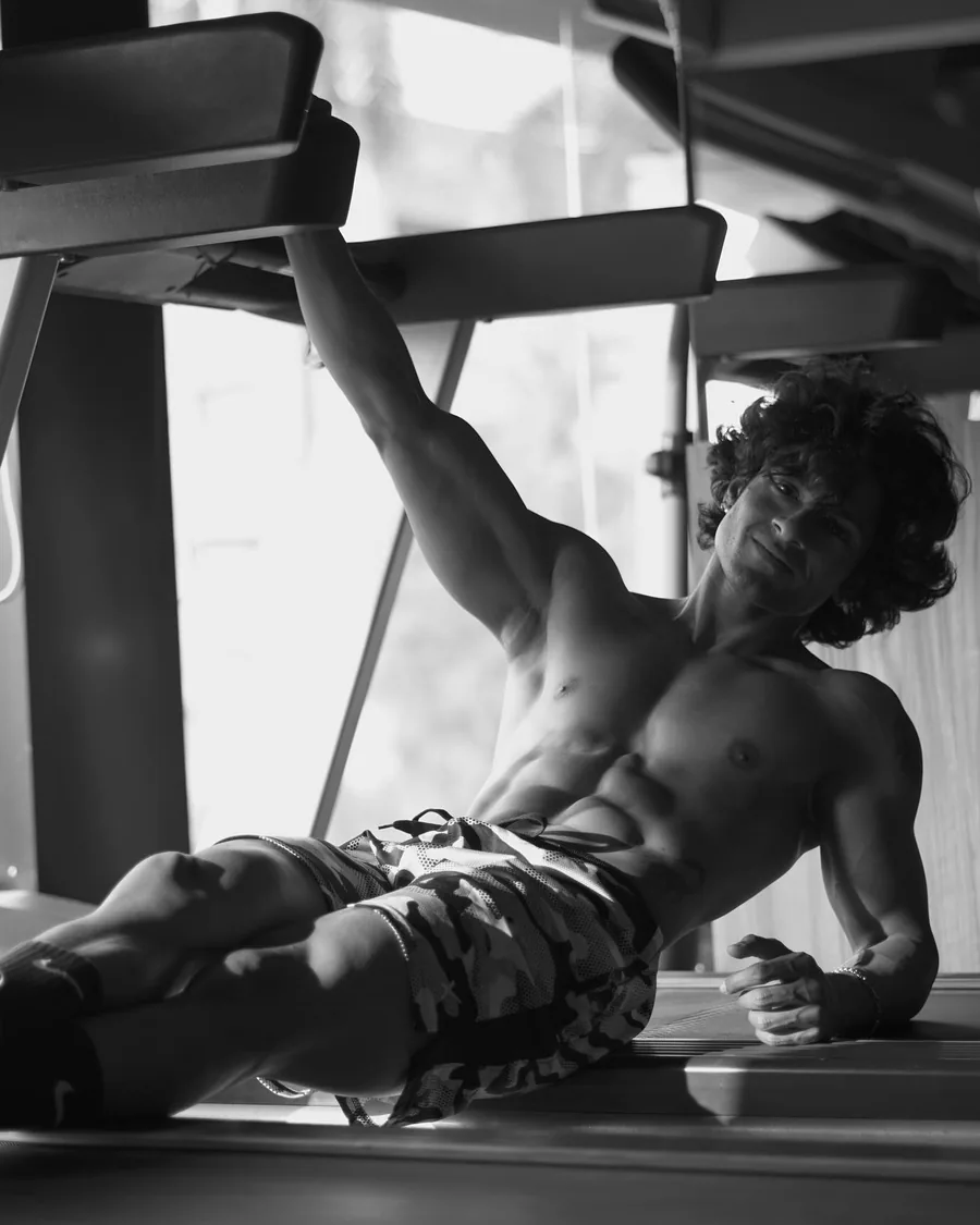 Rajdeep resting on a gym bench, black and white
